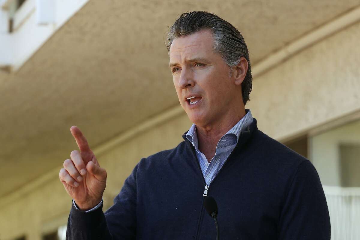 Gov. Gavin Newsom gives an update on the state's initiative to provide housing for homeless Californians to help stem the coronavirus, during a visit to a Motel 6 participating in the program in Pittsburg, Calif., Tuesday, June 30, 2020. Newsom announced that more than 15,000 rooms have been acquired and more than 14,000 people have been given places to stay statewide under the Project Room key program started in April. The governor also said he plans to announce on Wednesday plans to "toggle back" the states stay-at-home order. (AP Photo/Rich Pedroncelli, Pool)