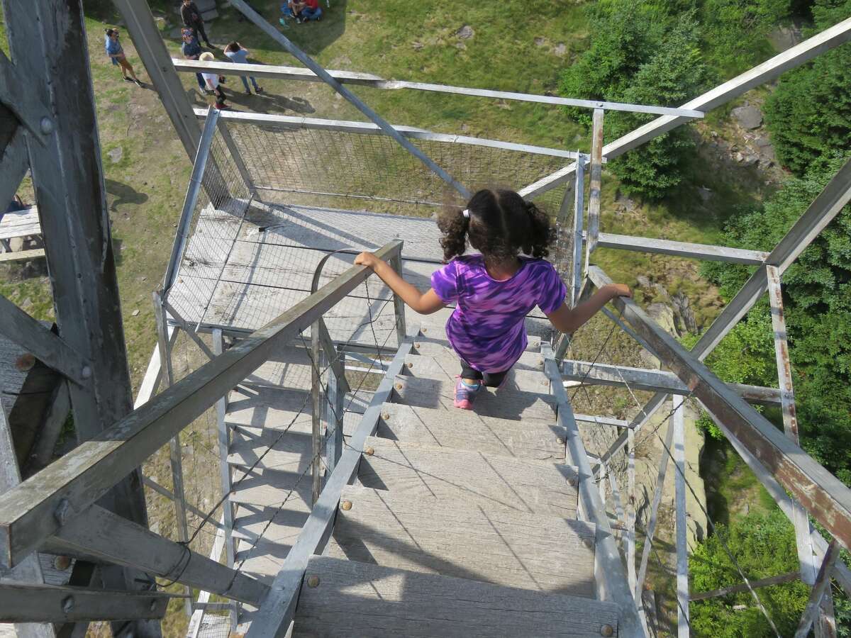 Outdoor writer Gillian Scott's daughter descends the steps of the Hunter Mountain fire tower in the Catskills in 2016. (Herb Terns / Times Union)