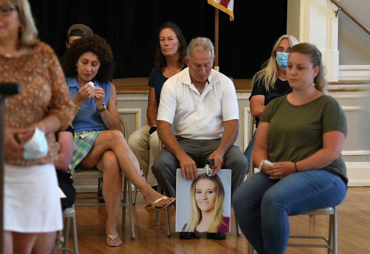Sam Bursese, center, who lost his daughter, Savannah Bursese, in the Oct. 6, 2018 Schoharie limousine crash that killed 20 people, holds a photo of Savannah during a news conference where family members voiced their disappointment and frustration in the plea-bargain process in the prosecution of Nauman Hussain, the who operated the company that owned the limo. (Will Waldron/Times Union)