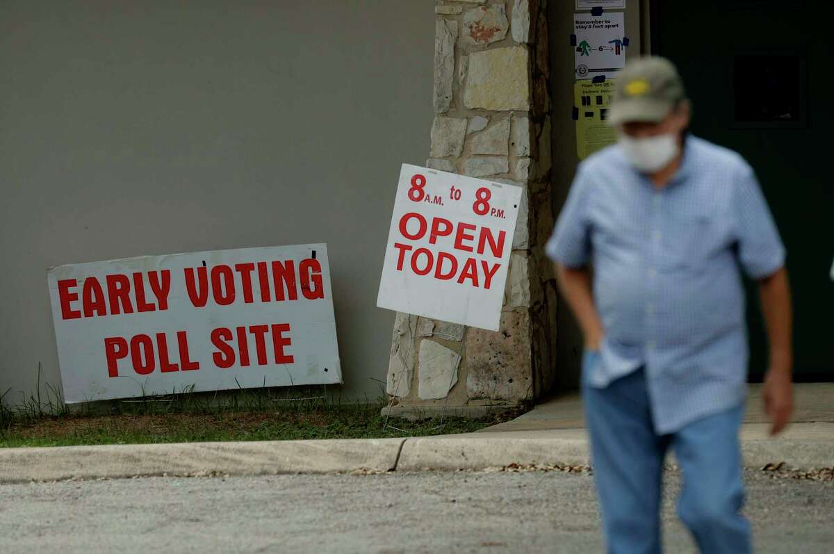 An early voter leaves a polling site, Tuesday, July 7, 2020, in San Antonio. Polling site workers are wearing masks and taking other precautions due to the COVID-19 outbreak. (AP Photo/Eric Gay)
