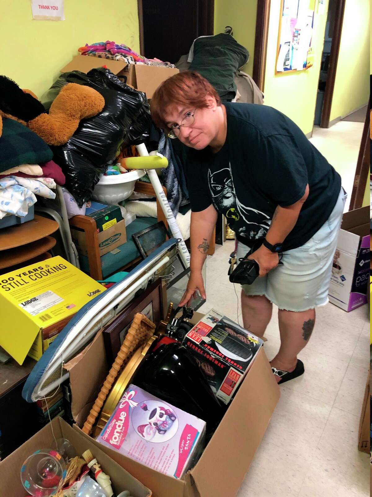 OBK staff member Amy Smith sorts through donations in preparation for the big day. (Courtesy photo)