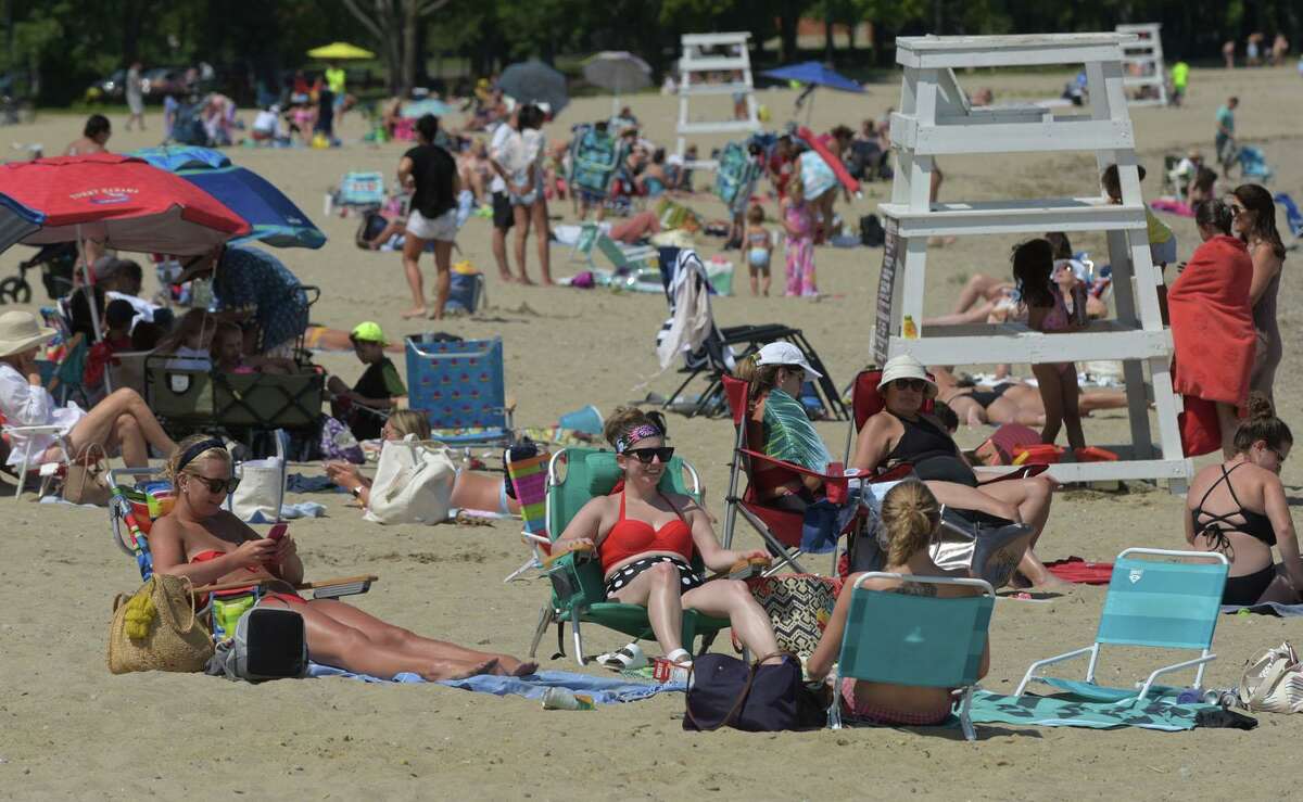 File photo of beachgoers at Calf Pasture Beach Thursday, July 16 2020, in Norwalk, Conn.