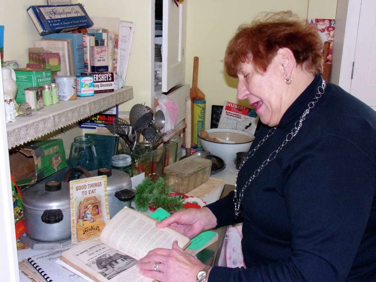Longtime Sebewaing resident Carol Truemner looks through some historical archives while reflecting on the town's past. (Tribune File Photo)