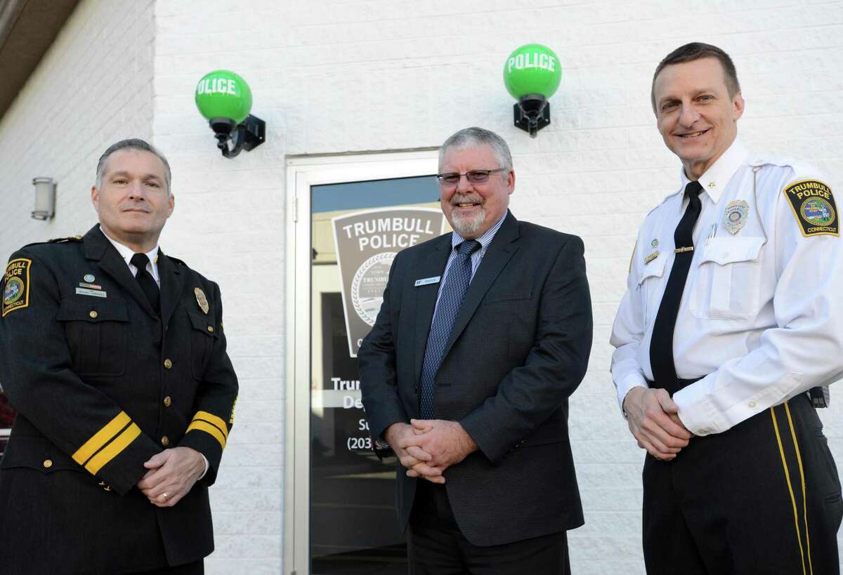 Trumbull Police Chief Michael Lombardo, Westfield Trumbull Manager Patrick Madden and Deputy Chief Glenn Byrnes stand outside the new police substation at the Westfield Trumbull Mall on its first day open Tuesday, Nov. 17, 2015.