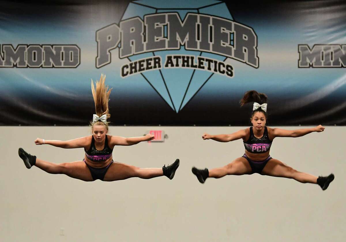 Alex Joslyn, 15, of Latham, left, and Miranda Diaz, 14, of Albany, practice during tryouts for the group's hip-hop competitive team at Premier Cheer Academy on Friday, July 17, 2020 in Albany, N.Y. (Lori Van Buren/Times Union7