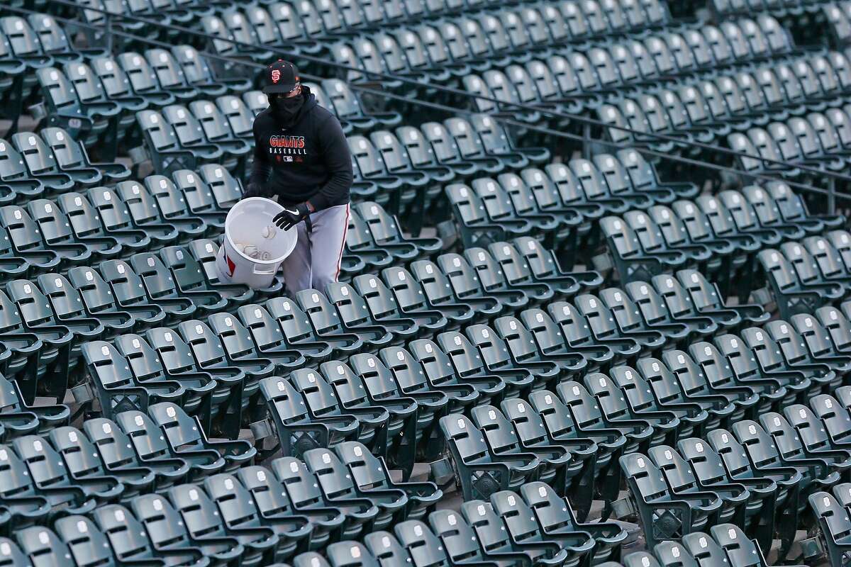 Foul balls are put into a used bin during a San Francisco Giants intrasquad game at Oracle Park on Saturday, July 18, 2020, in San Francisco, Calif. The balls won?•t be used in the game anymore to prevent the spread of germs and viruses, amid the coronavirus pandemic.