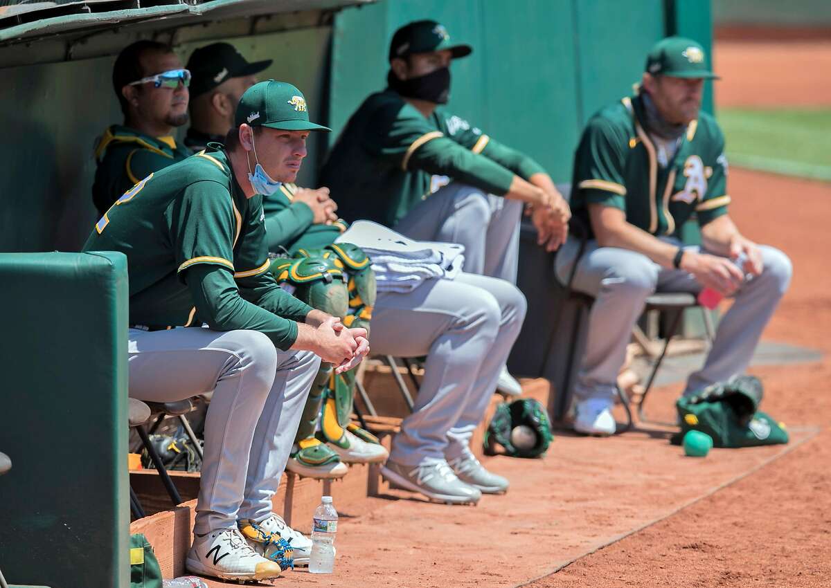 The A's bullpen watches the action as the Oakland Athletics played in a simulated game at the Coliseum in Oakland, Calif., on Sunday, July 19, 2020.