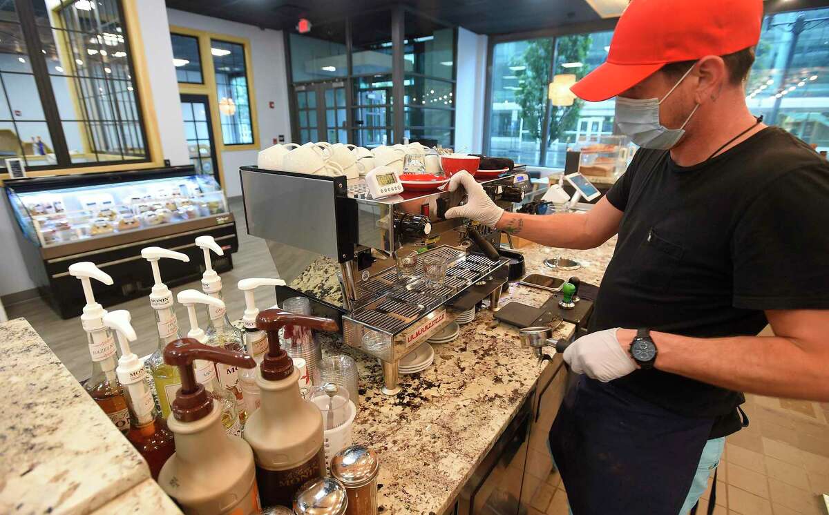 Barista Josh Smith make a signature house latte at Honey Joe's Family Coffeehouse on July 10, 2020.