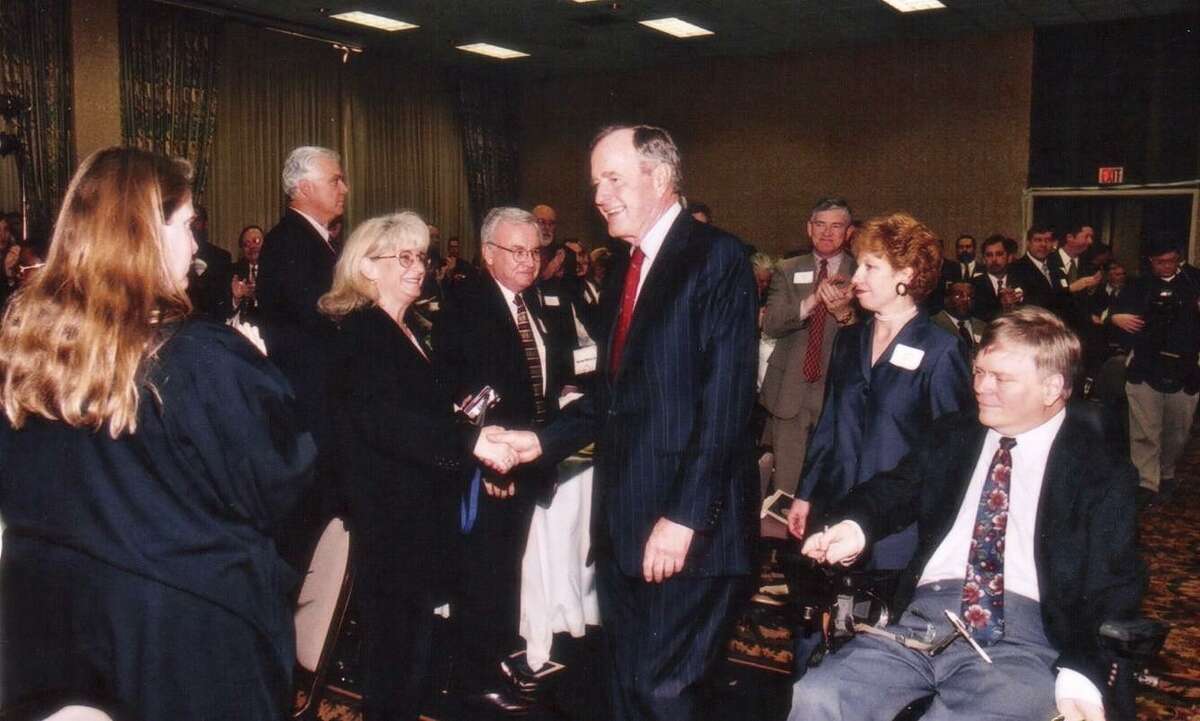 Former President George H.W. Bush celebrates with ADA advocates, including Lex Frieden, right, in 2000 at the Houstonian Hotel.