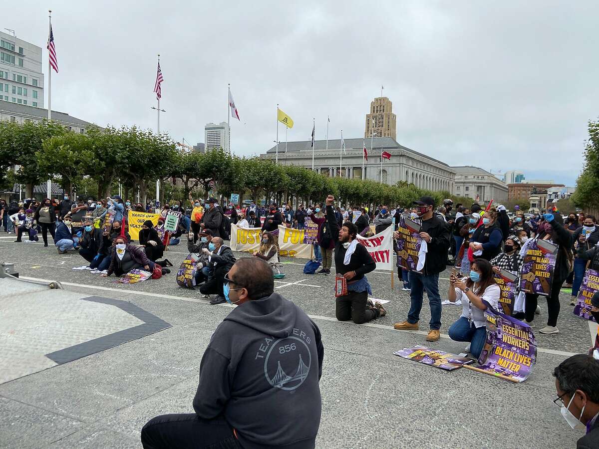 Labor union members gathered in front of San Francisco City Hall on Monday, call for racial justice and labor rights.