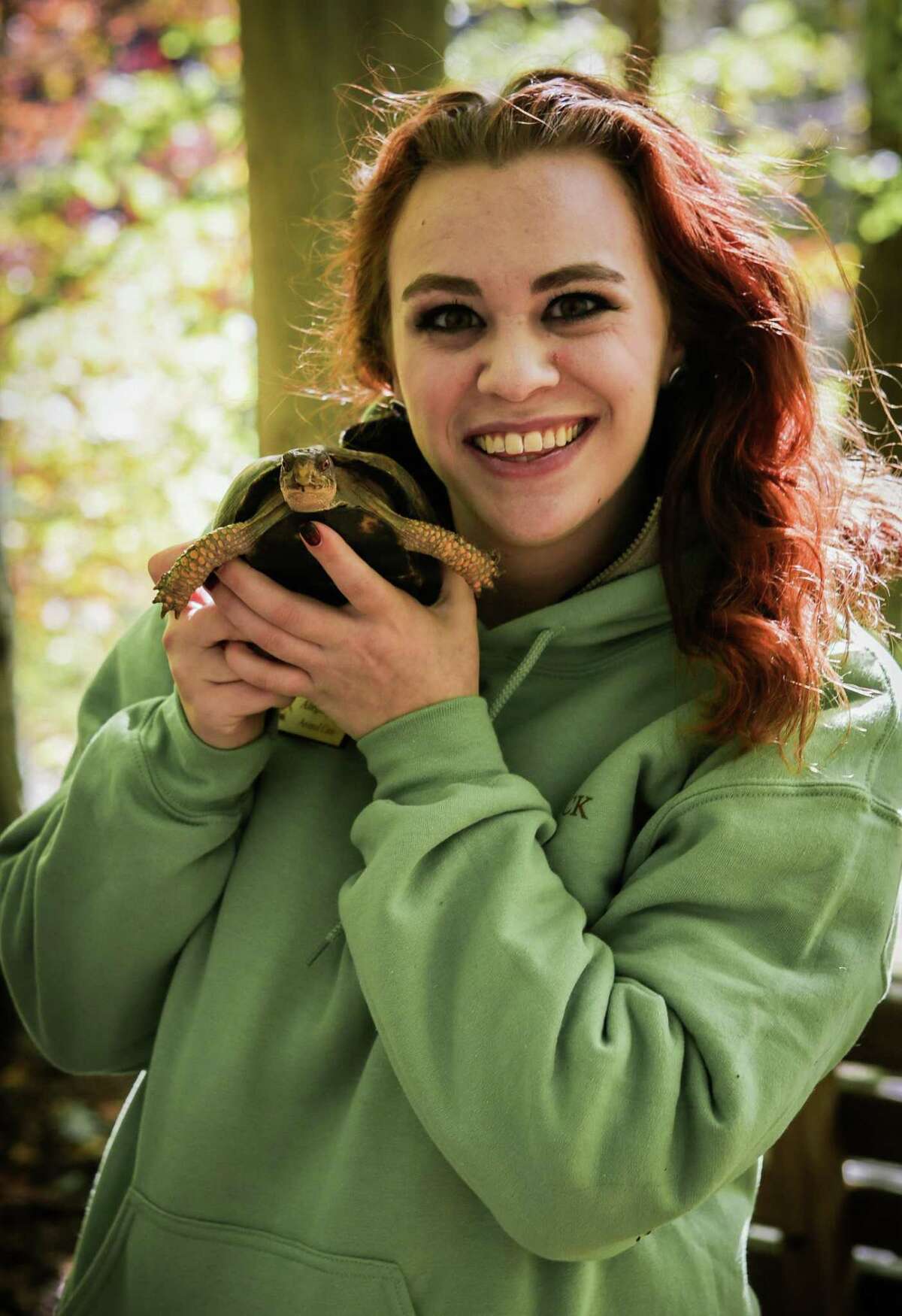 Elma the turtle, held by educator Allegra Jacobs, is one of the ambassador animals from Woodcock Nature Center expected to visit the Nod Hill Brewery on July 26.