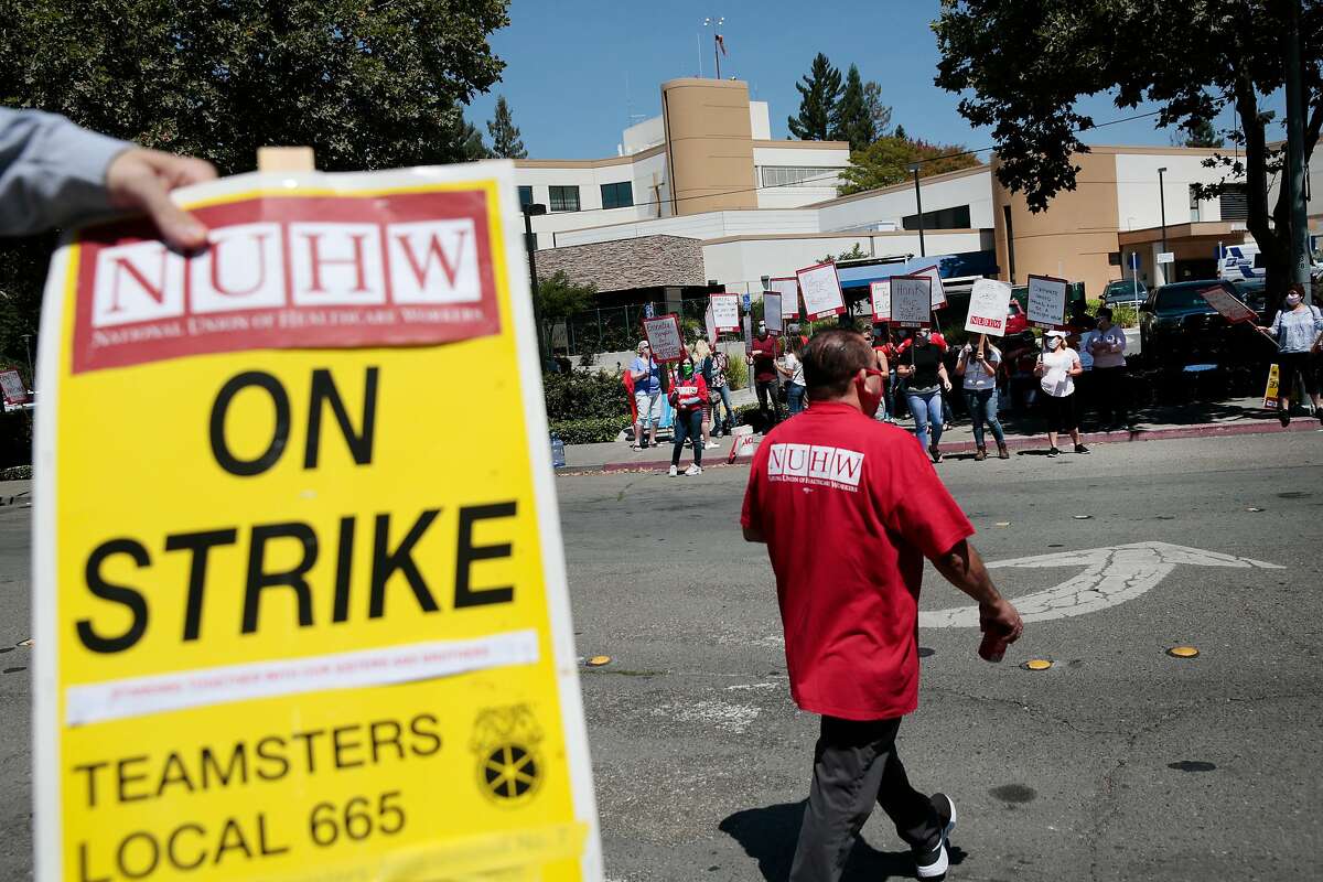 Members of NUHW (National Union of Healthcare Workers) strike outside Santa Rosa Memorial Hospital in Santa Rosa, California, Monday, July 20, 2020. Santa Rosa Memorial Hospital workers are protesting lack of PPE, insufficient staffing, lack of a contract, benefit cuts, etc. Ramin Rahimian/Special to The Chronicle