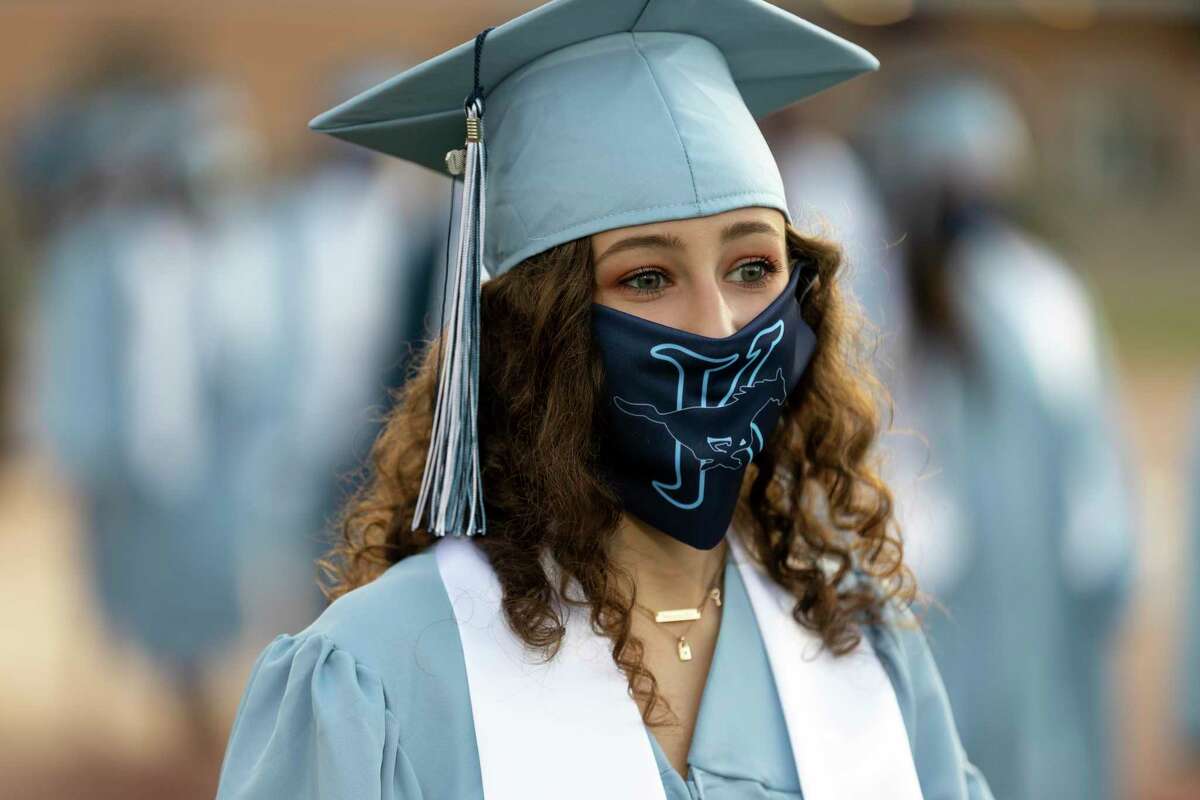 A graduate wears a custom face mask that was given to each graduate during a Kingwood High School graduation ceremony held at Turner Stadium in Humble, Monday, July 20, 2020. An estimated 520 students walked across the stage to celebrate commemorate their graduation.