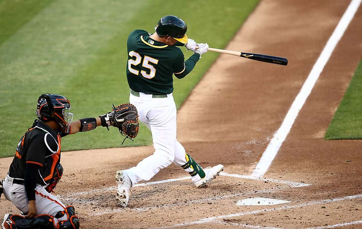 OAKLAND, CALIFORNIA - JULY 20: Stephen Piscotty #25 of the Oakland Athletics hits a home run in the second inning against the San Francisco Giants during their exhibition game at Oakland-Alameda County Coliseum on July 20, 2020 in Oakland, California. (Photo by Ezra Shaw/Getty Images)