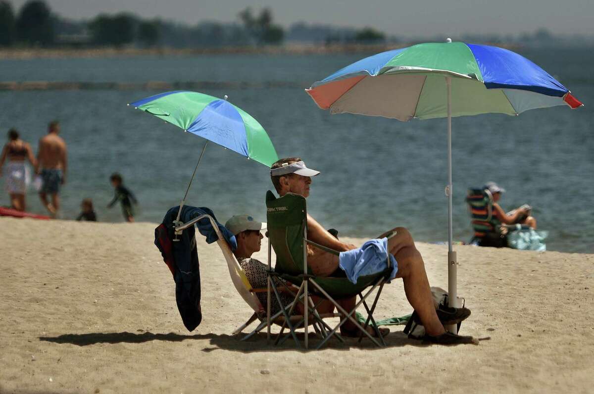 Restricted to Norwalk residents only on weekends, beach goers try to beat the heat at Calf Pasture Beach in Norwalk, Conn. on Monday, July 20, 2020.