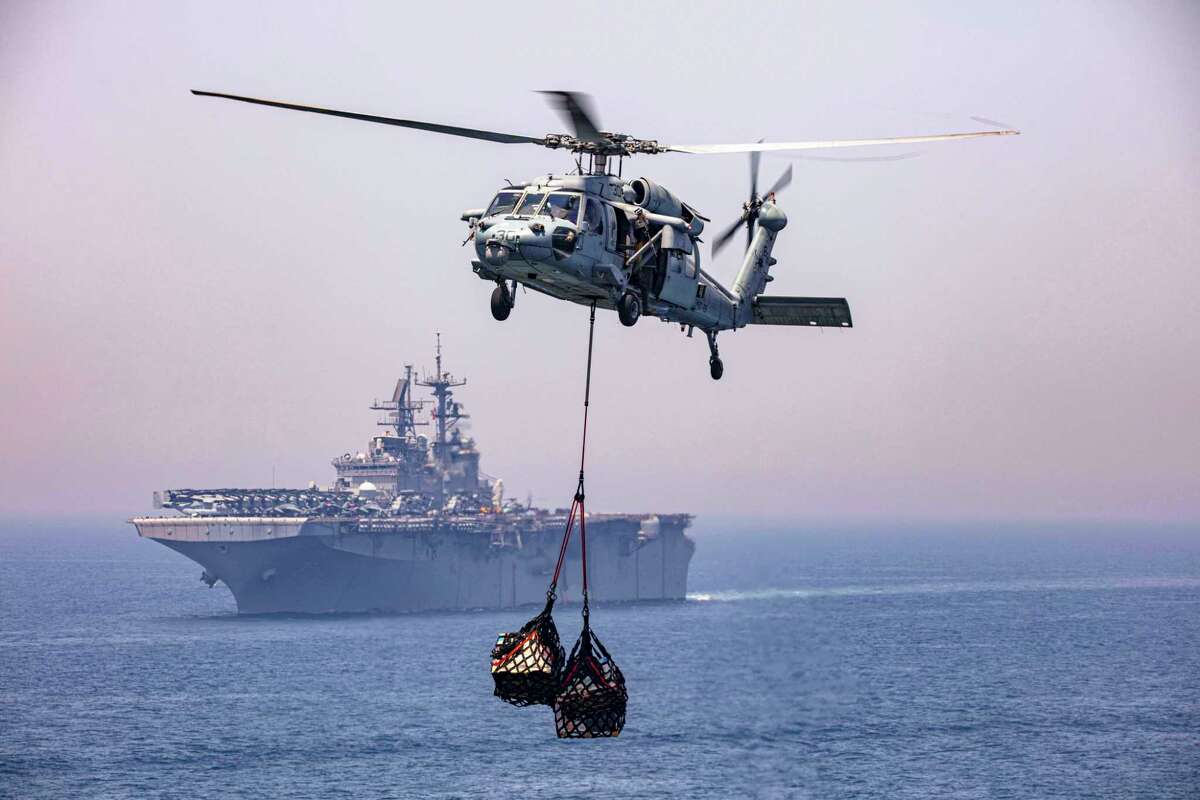 An MH-60S Seahawk helicopter during a supply lift on April 25, 2020, while attached to the "Dragon Whales" of Helicopter Sea Combat Squadron (HSC) 28 in the vicinity of the amphibious assault ship USS Bataan (LHD 5). (U.S. Navy photo by Mass Communication Specialist 2nd Class Lyle Wilkie/Released)