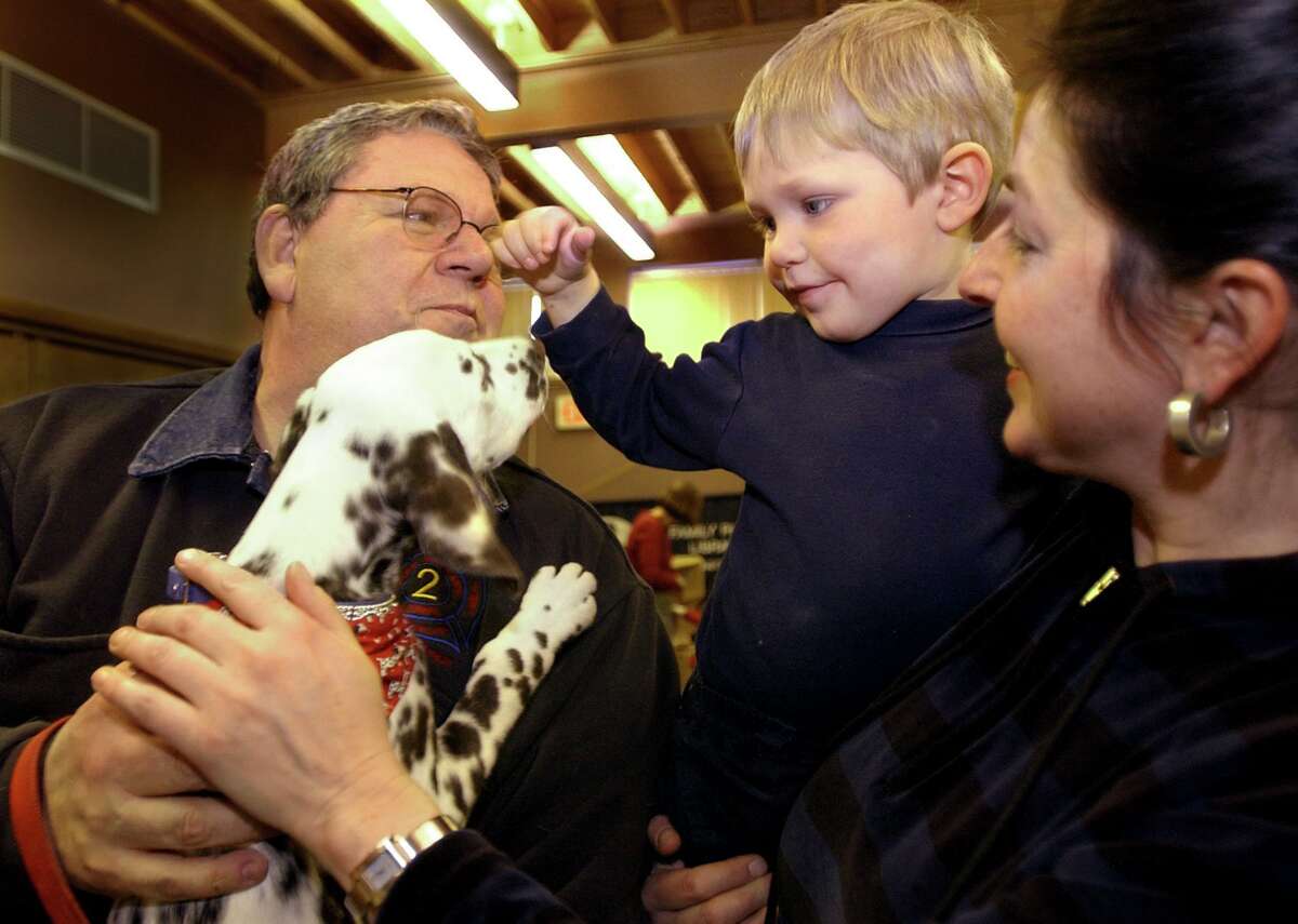 Tom Lenart is the new chairman of the Derby Police Commission. Here he is photographed in 2004 showing his dalmation puppy, Sky Blue to Maximalian Wilhelm, and his mother Linda of Seymour during a Child Safety Work shop at the Derby Neck Library.