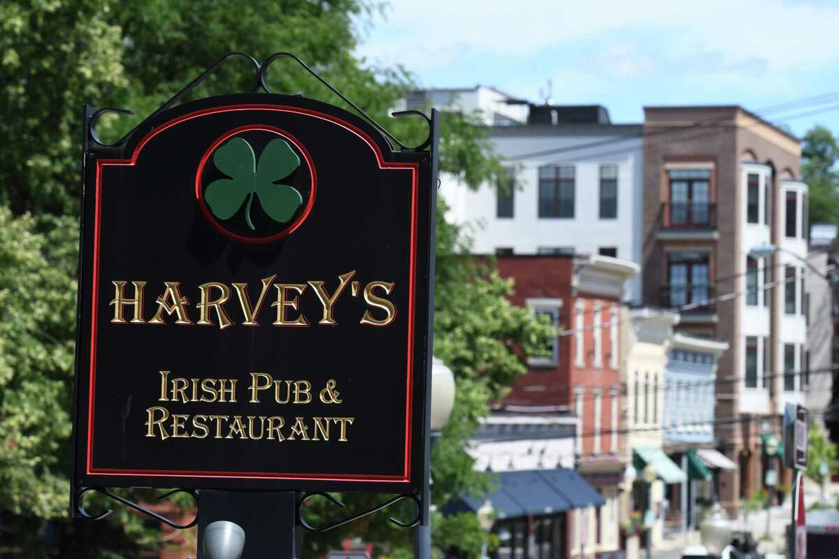 Sign outside Harvey's Restaurant and Bar on Phila Street on Tuesday, July 21, 2020, in Saratoga Springs, N.Y. Co-owners Matthew Bagley and Adam Humphrey introduced $1 snacks to tweak the new state rules requiring food be sold with every initial drink order. Their Cuomo chips have gained national notoriety. (Will Waldron/Times Union)