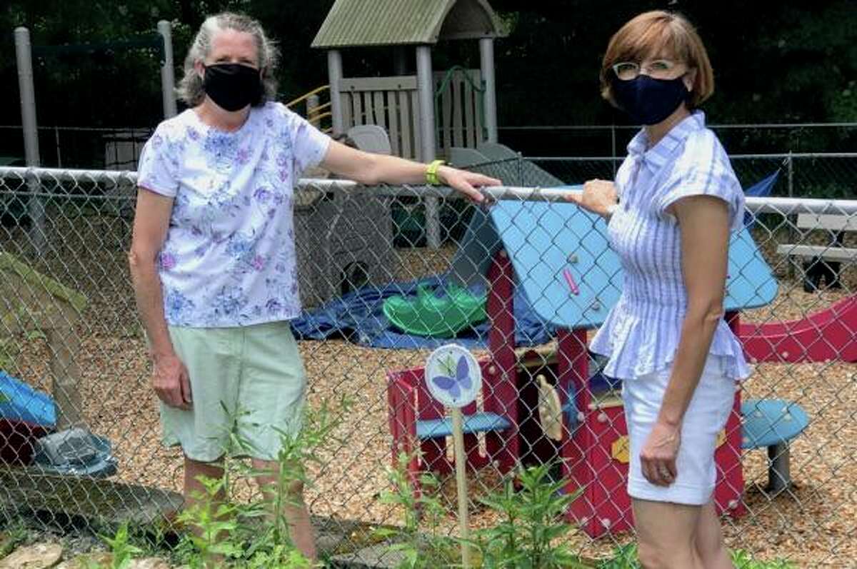 Teachers Anne Gaston and Sarah Harris stand by the new pollinator garden at Zion’s Hill Preschool.
