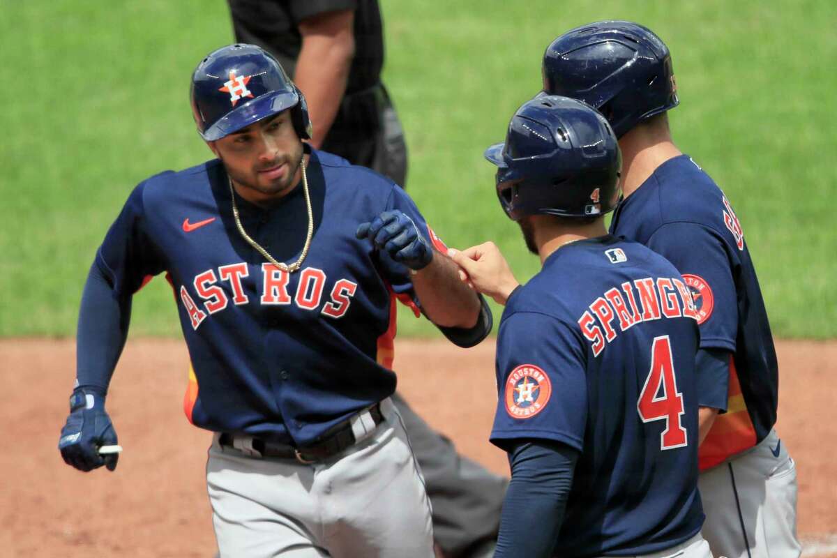 Houston Astros Alex De Goti, left, is congratulated by teammates George Springer (4) and Dustin Garneau, right, after his three-run home run during the fifth inning of an exhibition baseball game at Kauffman Stadium in Kansas City, Mo., Tuesday, July 21, 2020. (AP Photo/Orlin Wagner)