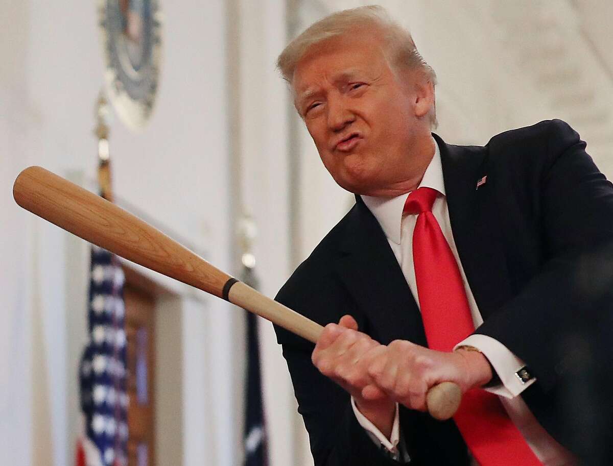 WASHINGTON, DC - JULY 02: U.S. President Donald Trump holds a baseball bat while looking at exhibits during a Spirit of America Showcase in the Entrance Hall of the White House July 02, 2020 in Washington, DC. The president visited with representatives from invited companies like Weber-Stephen Products, the Texas Timber Wood Bat Company, Scars & Stripes Coffee, Carolina Pie, Fruit of the Earth, Nautilus Fishing Company and others. (Photo by Chip Somodevilla/Getty Images) ***BESTPIX***