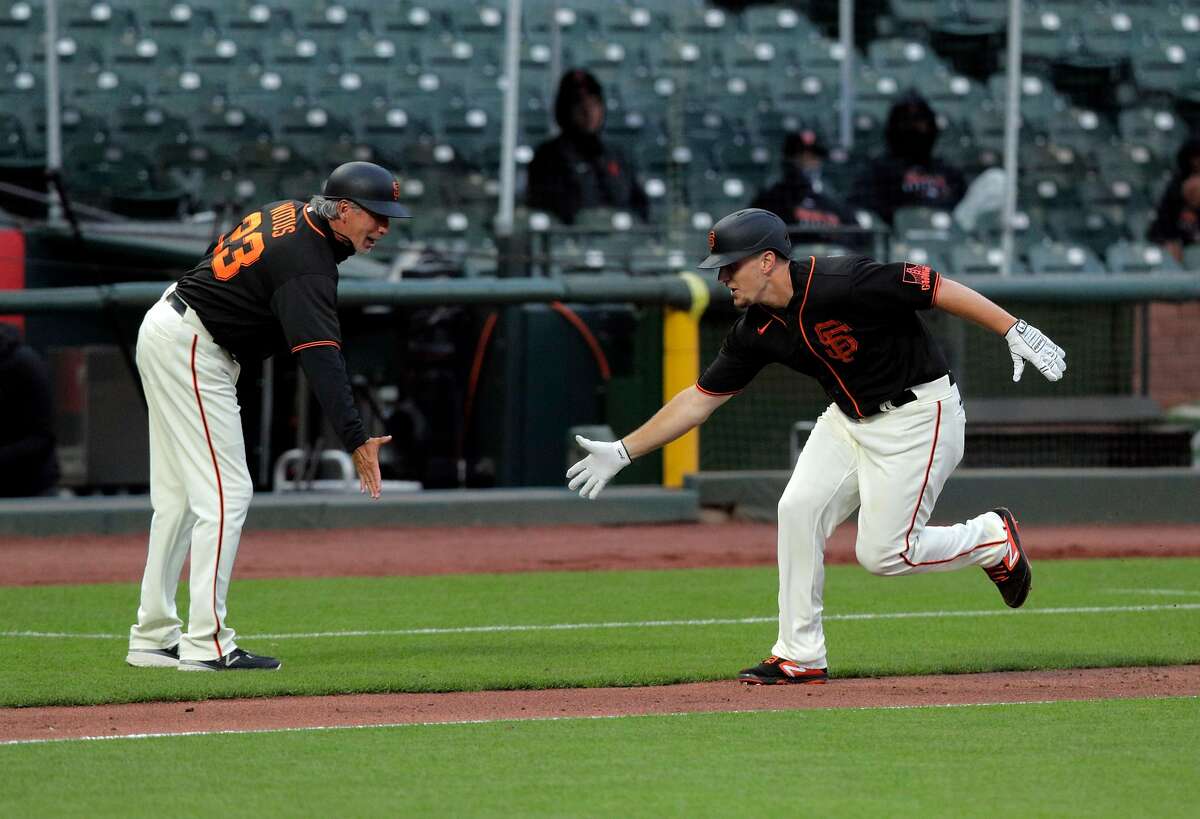 Mauricio Dubon and first base coach Alyssa Nakken walk back to the