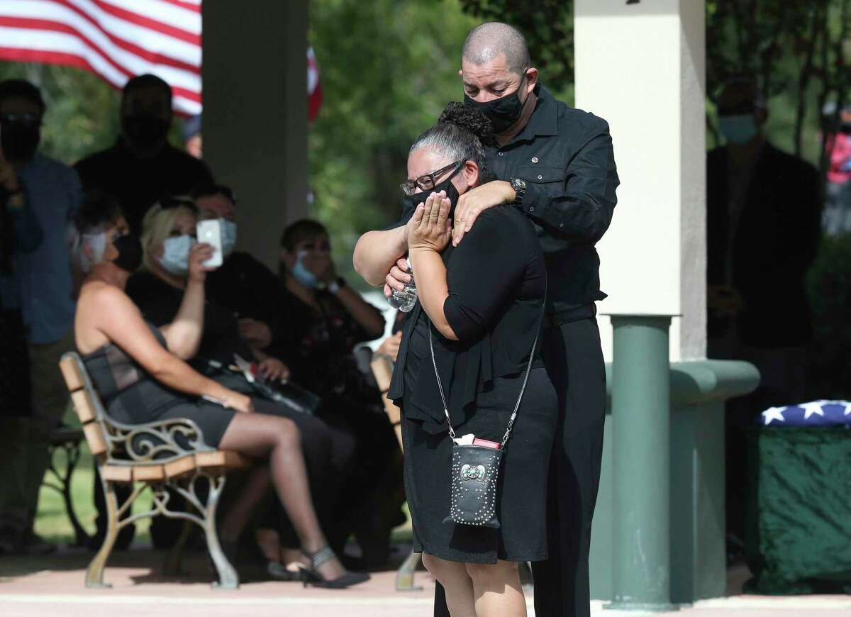 Blanca Ibarria, mother of Spc. Vincent Sebastian Ibarria, watches as a set of homing pigeons are released before her son is laid to rest at Fort Sam Houston National Cemetery on Wednesday.