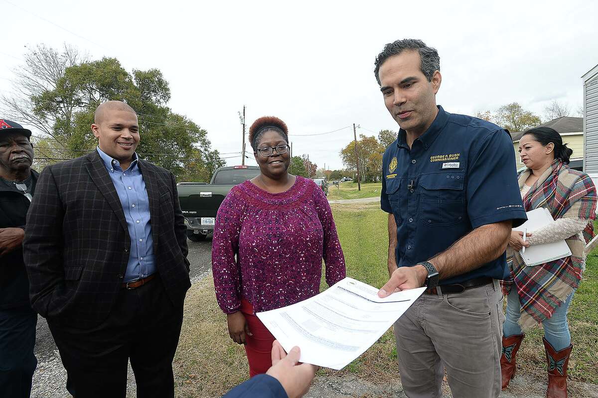 Texas Land Commissioner George P. Bush is given an assistance application for Port Arthur resident Havalisia Owens during a stop to her FEMA trailer and adjacent Harvey damaged home Wednesday. The Texas General Land Office rolled out their newest Homeowner Assistance Program in the region to further aid those still recovering from Tropical Storm Harvey. They also announced a FEMA extension on trailers as well as a new sales program. Photo taken Wednesday, November 28, 2018 Kim Brent/The Enterprise