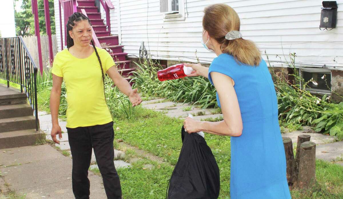 In Middletown Wednesday, Lt. Gov. Susan Bysiewicz Wednesday hands out a census water bottle after a Grand Street resident assured her she had submitted her form.