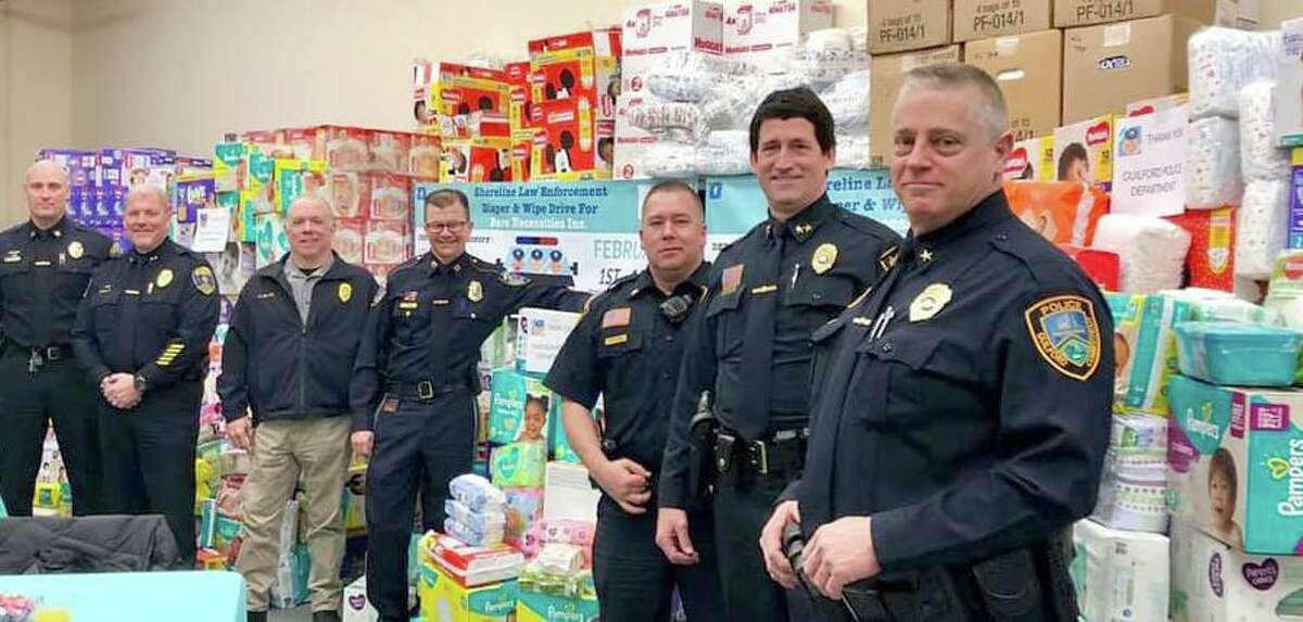 Guilford Deputy Chief Warren “Butch” Hyatt Jr., right, and Chief of Police Jeffery Hutchinson, second from right, at a regional diaper drive in 2019.