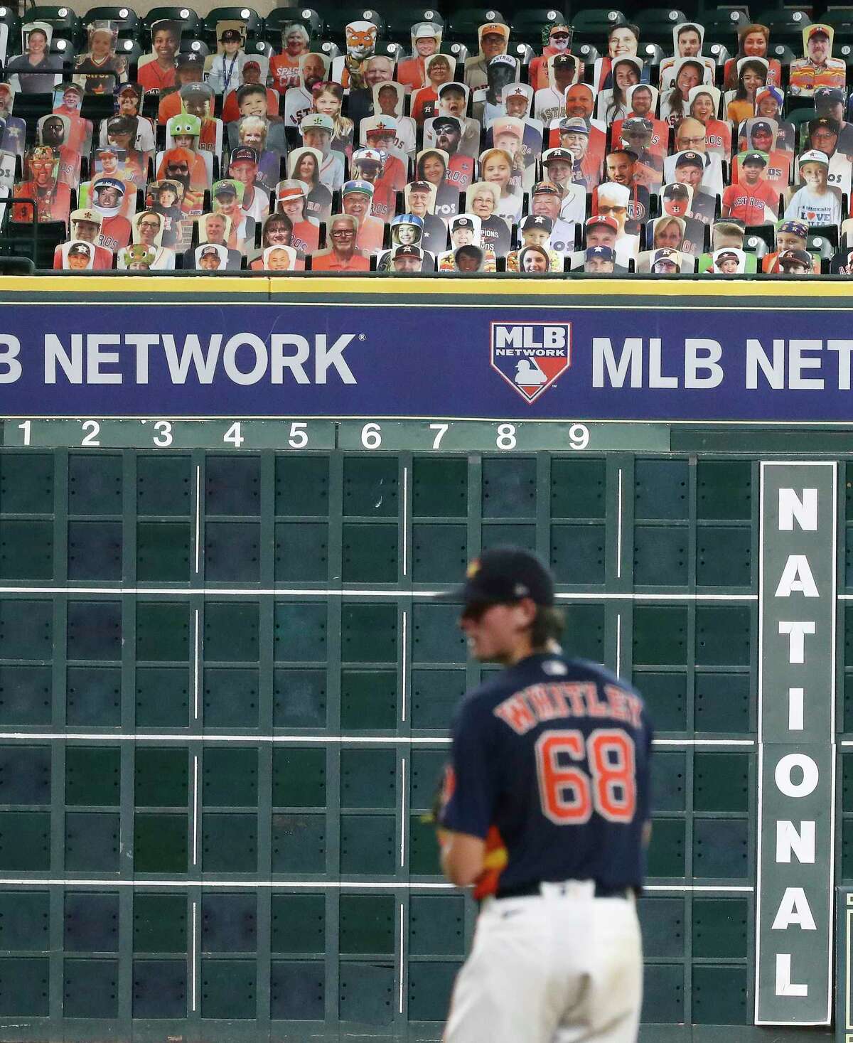 Houston Astros pitcher Forrest Whitley pitches with cardboard cutouts of fans in the Crawford Boxes behind him during an intrasquad game during the Astros summer camp at Minute Maid Park, Wednesday, July 22, 2020, in Houston.