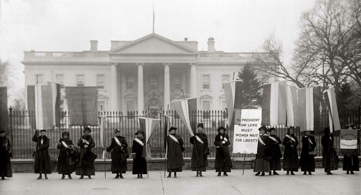 This undated image released by PBS shows suffragists picketing outside the White House.