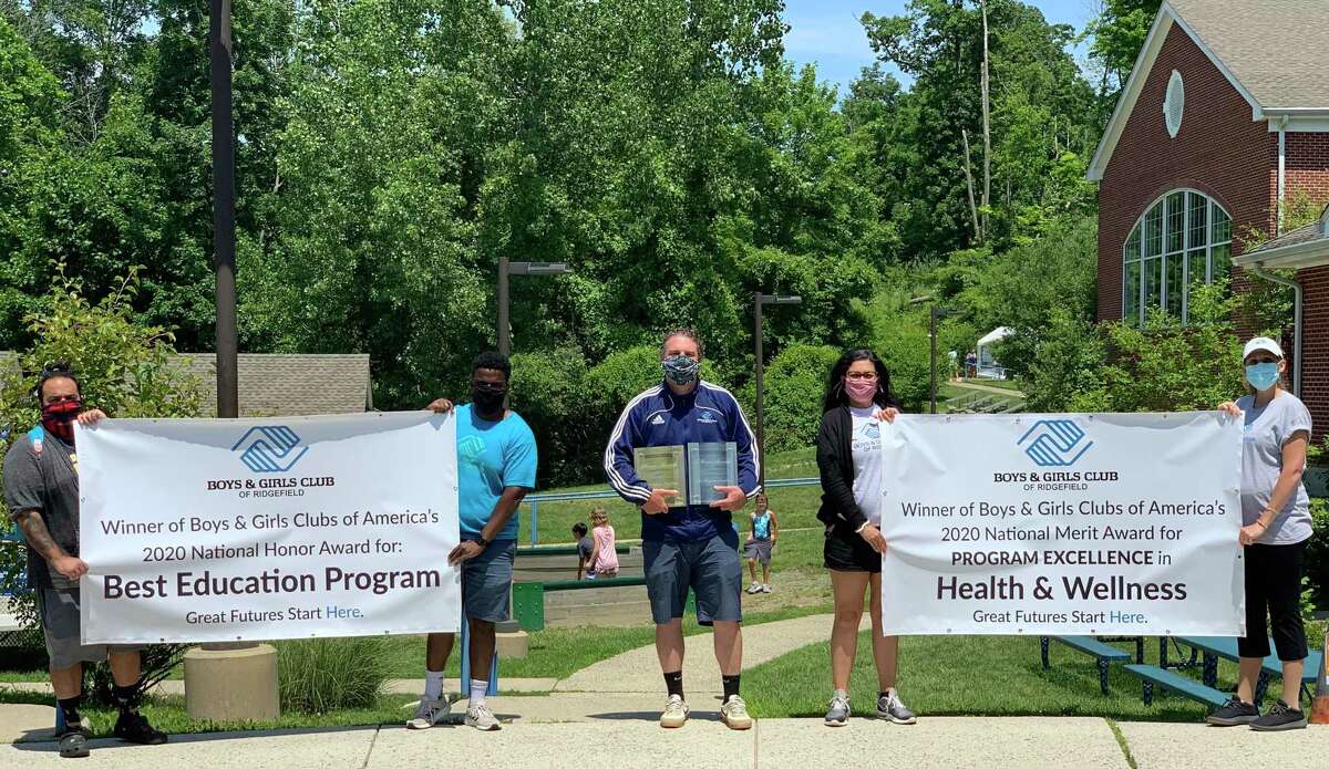 Jeff Goncalves, program director; Devon Lawrence, program manager; Mike Flynn, chief executive officer; Kristin Goncalves, associate executive director, and Jess Podrazky, senior program director pose with the National Honor Award for Education and the National Merit Award for Health and Life Skills awarded to them at Boys & Girls Clubs of America's Virtual National Conference in May. The club has received seven National Honor Awards for Program Excellence within the past six years.