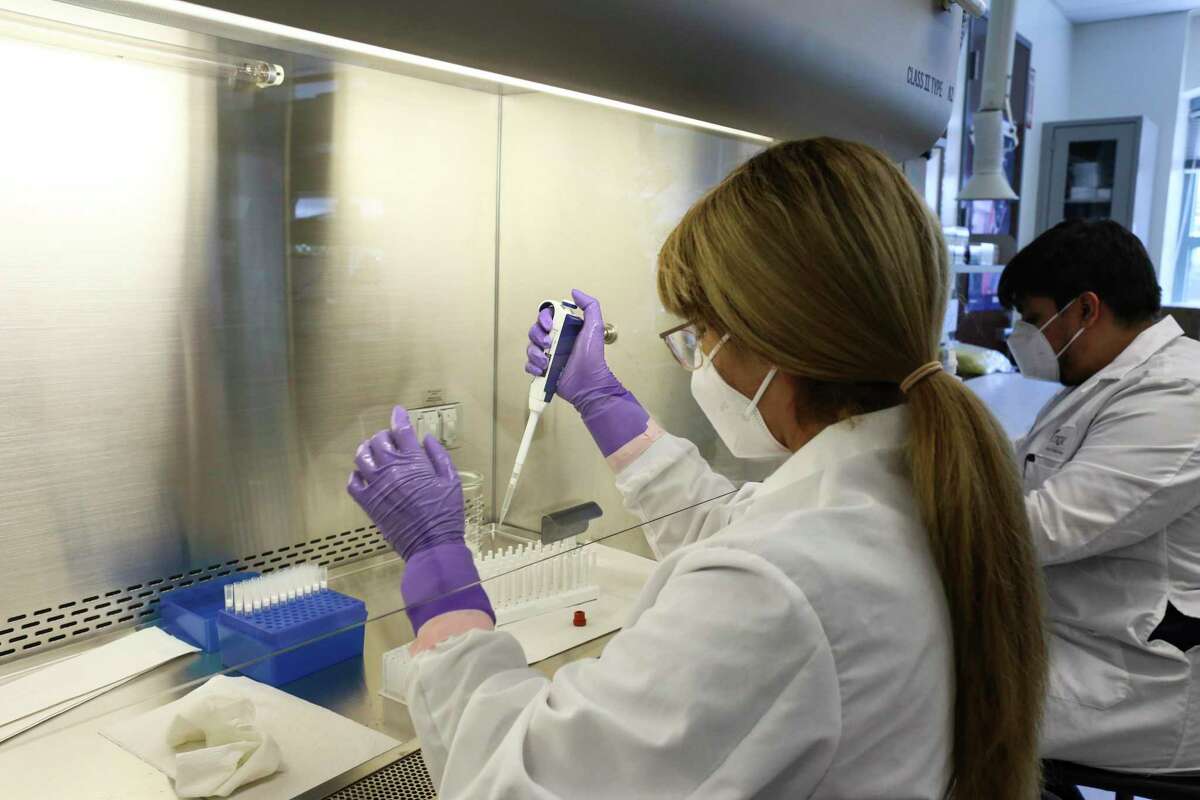 Lab technician Thalia Rios withdraws a small amount of liquid from a COVID-19 swab sample for testing Friday, July 10, 2020, at the UT Health RGV Clinical Lab on the University of Texas-Rio Grande Valley campus in Edinburg, Texas
