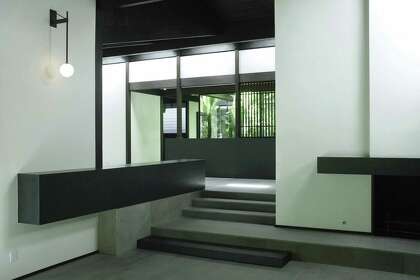 From the front, cantilevered living room, these steps lead to the main part of the home. Interior trim and woodwork is Siberian larch, stained black, and the flooring here is Texas limestone.