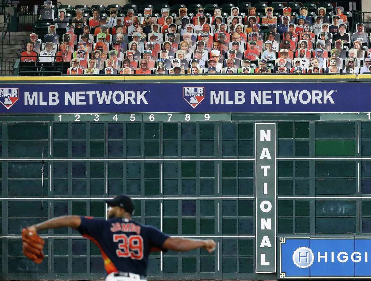 Houston Astros pitcher Josh James pitches with cardboard cutouts of fans in the Crawford Boxes behind him during an intrasquad game during the Astros summer camp at Minute Maid Park, Wednesday, July 22, 2020, in Houston.