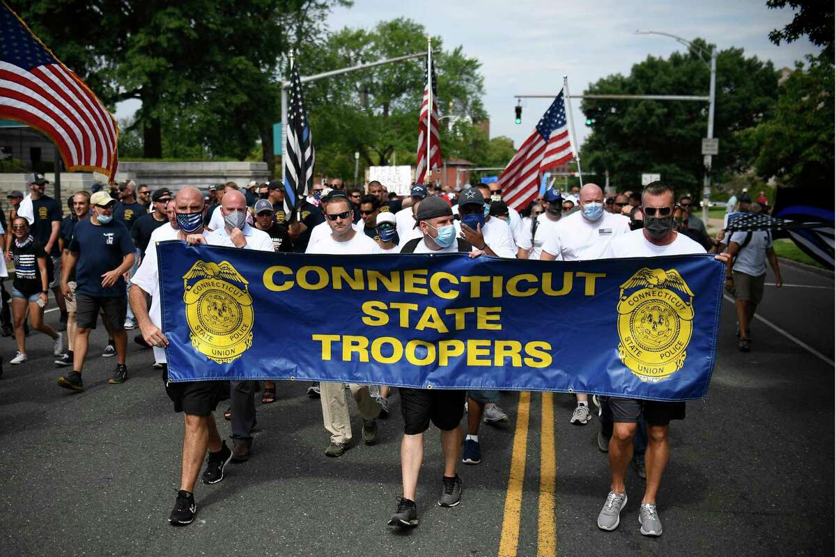 People participating in a “Back the Blue” rally to show support for law enforcement officers march toward the State Capitol, Thursday in Hartford.