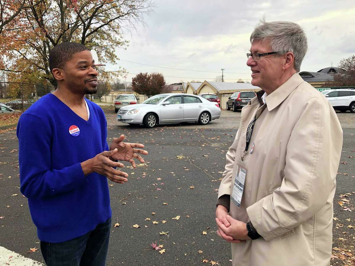 Stratford Democratic Town Council Member David Harden, left, talking with District 8 Democratic nominee James Simon outside Chapel Street School on Election Day, Nov. 5, 2019.