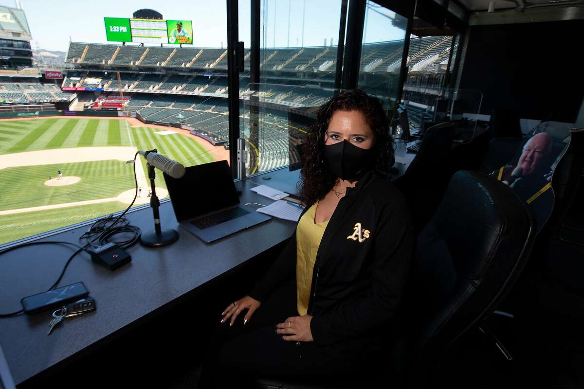 Oakland Athletics public address announcer Amelia Schimmel poses for a photograph in the announcer’s booth at the Coliseum before the start of the regular season Thursday, July 23, 2020 in Oakland, Calif. Schimmel is filling in for long-time A’s PA man Dick Calahan during the coronavirus pandemic.