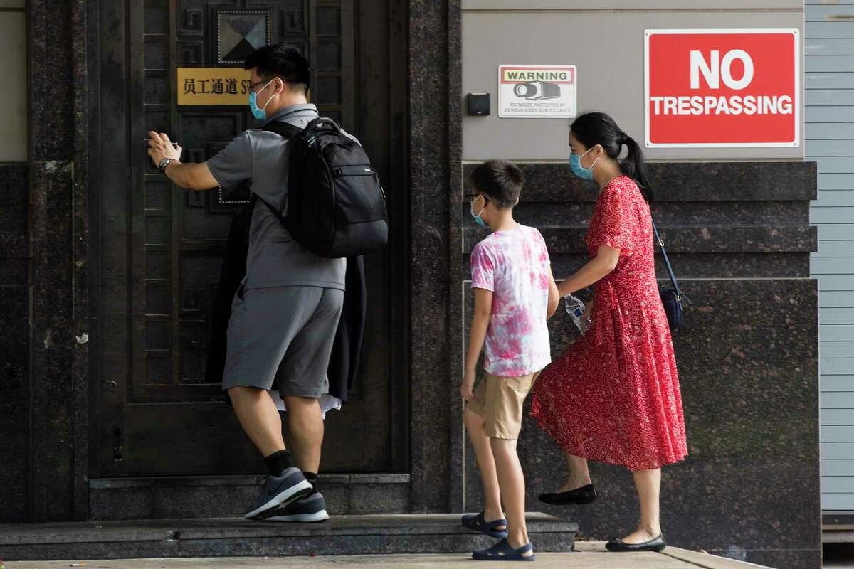 People walk into staff entrance of the Consulate General of China Thursday, July 23, 2020, in Houston.