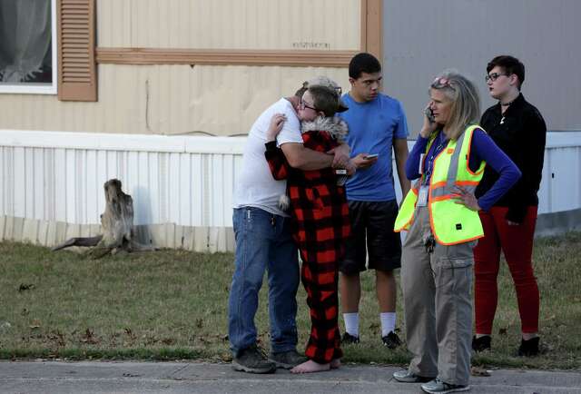 Ron Lawrence, left, comforts his daughter, Kallie Lawrence, 11, who knew Kameron Prescott, a 6-year-old boy who was shot by Bexar County Sheriff’s deputies while they were pursuing a suspect in the Pecan Grove mobile home park in Schertz on Dec. 21, 2017.