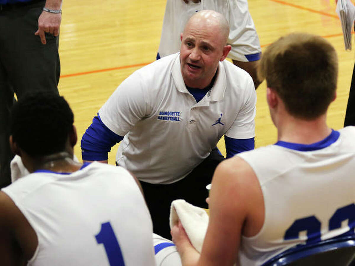 Marquette Catholic coach Steve Medford talks to his players on the bench during a timeout at the Okawville Tournament last season. Medford is 2020 Telegraph Small-Schools Boys Basketball Coach of the Year.