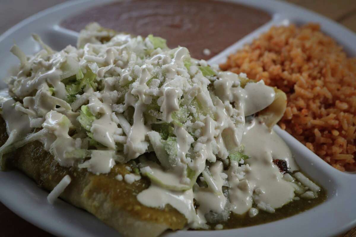 Veegos Restaurant's enchilada plate features three enchiladas served with a side of rice and refried beans, and topped with vegan mozzarella-style cheese.