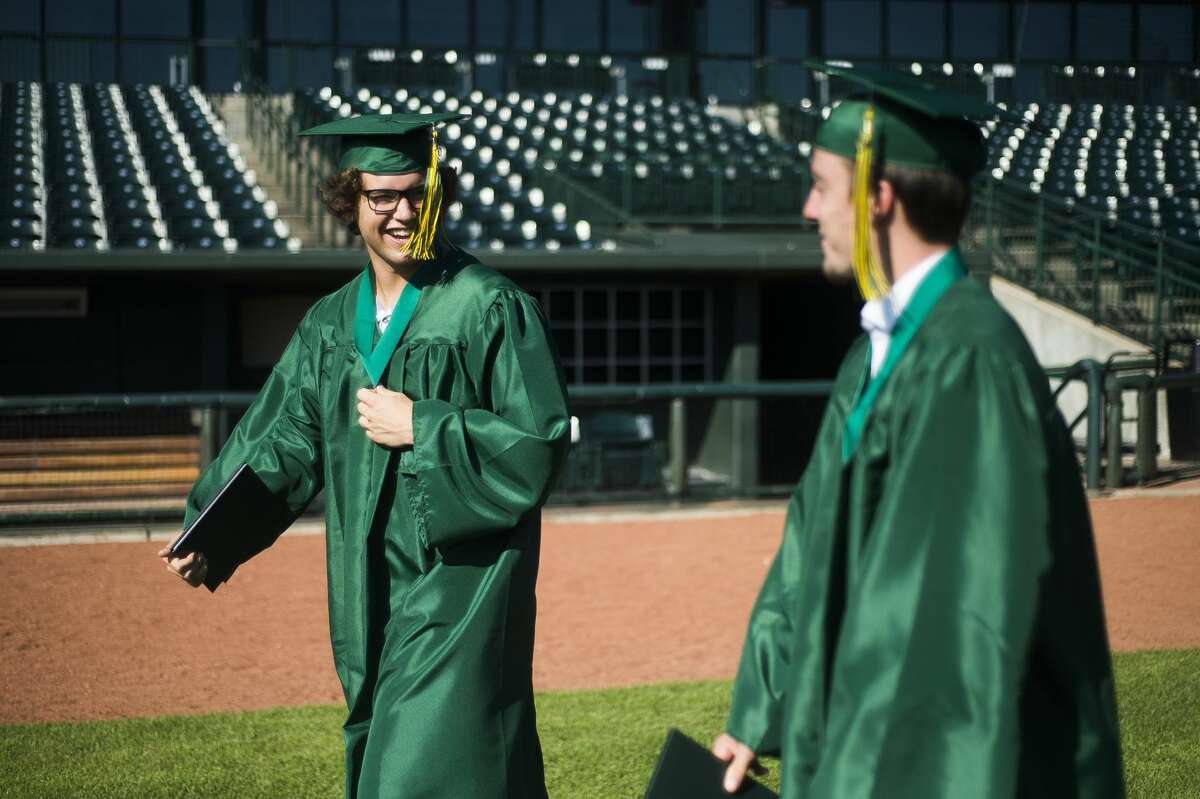Graduating seniors from H. H. Dow High School celebrate during a socially distanced commencement ceremony Friday, July 24, 2020 at Dow Diamond. (Katy Kildee/kkildee@mdn.net)