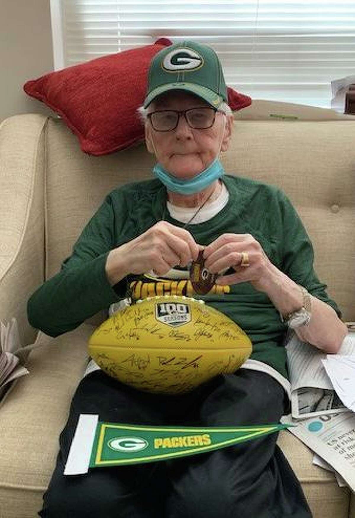 Duane Larsen with his haul of Green Bay Packers loot, including of course a hat.