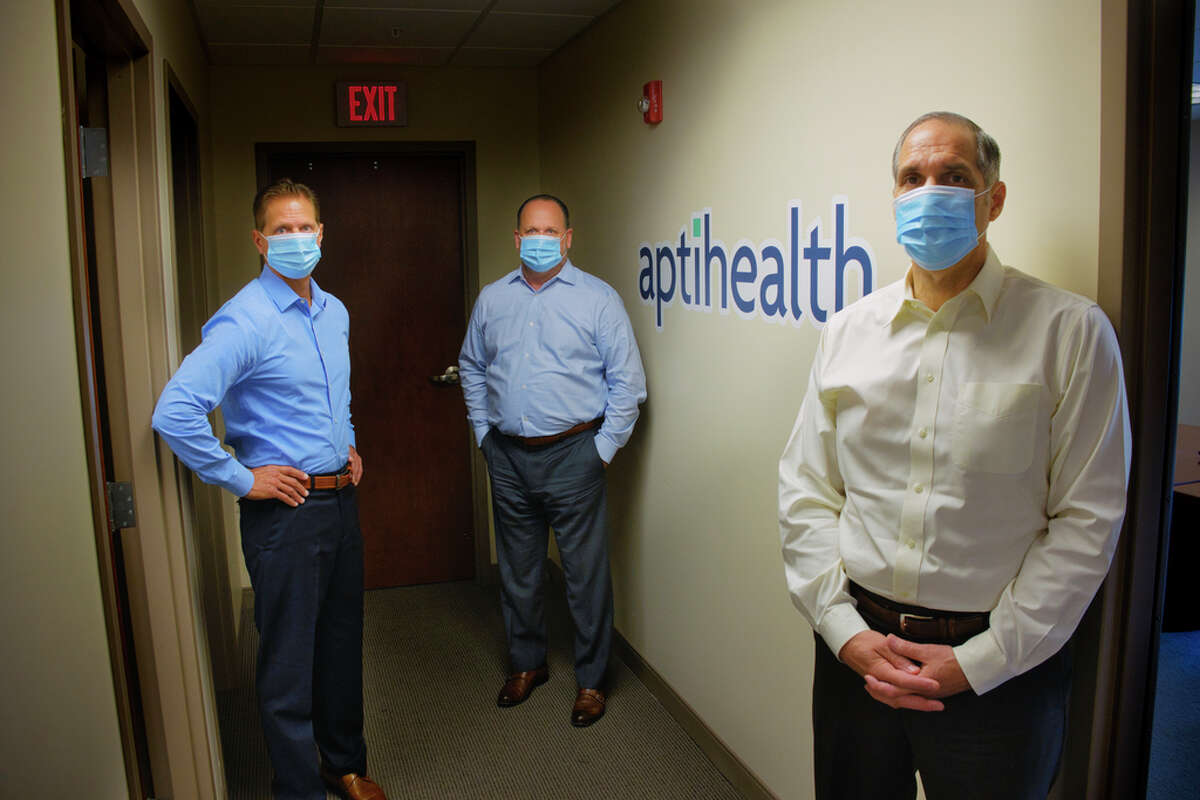 Carl Sgambati, M.D., left, chief medical officer for aptihealth, Dan Pickett, center, co-founder, president and CEO of aptihealth, and Alex Marsal, Ph.D., co-founder and chief clinical and science officer of aptihealth, pose for a photo at their office on Wednesday, July 22, 2020, in Troy, N.Y. (Paul Buckowski/Times Union)