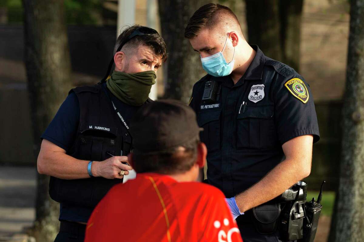 Social Worker Michael Hawkins, left, and Houston Police Department Crisis Intervention Response Team Officer Richard Pietruszynski respond to a mental health call July 2 in Houston.