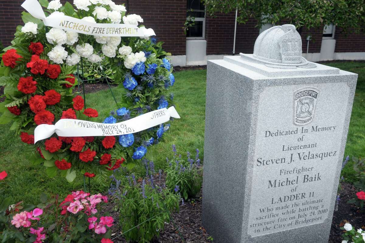 A wreath was in place Friday next to the memorial to Bridgeport firefighters Michel Baik and Lt. Steven Velasquez, at the fire station on Ocean Terrace. The firefighters died while fighting a fire on Elmwood Ave, in Bridgeport, Conn. ten years ago on July 24, 2010. Both men were assigned to Ladder Truck 11.