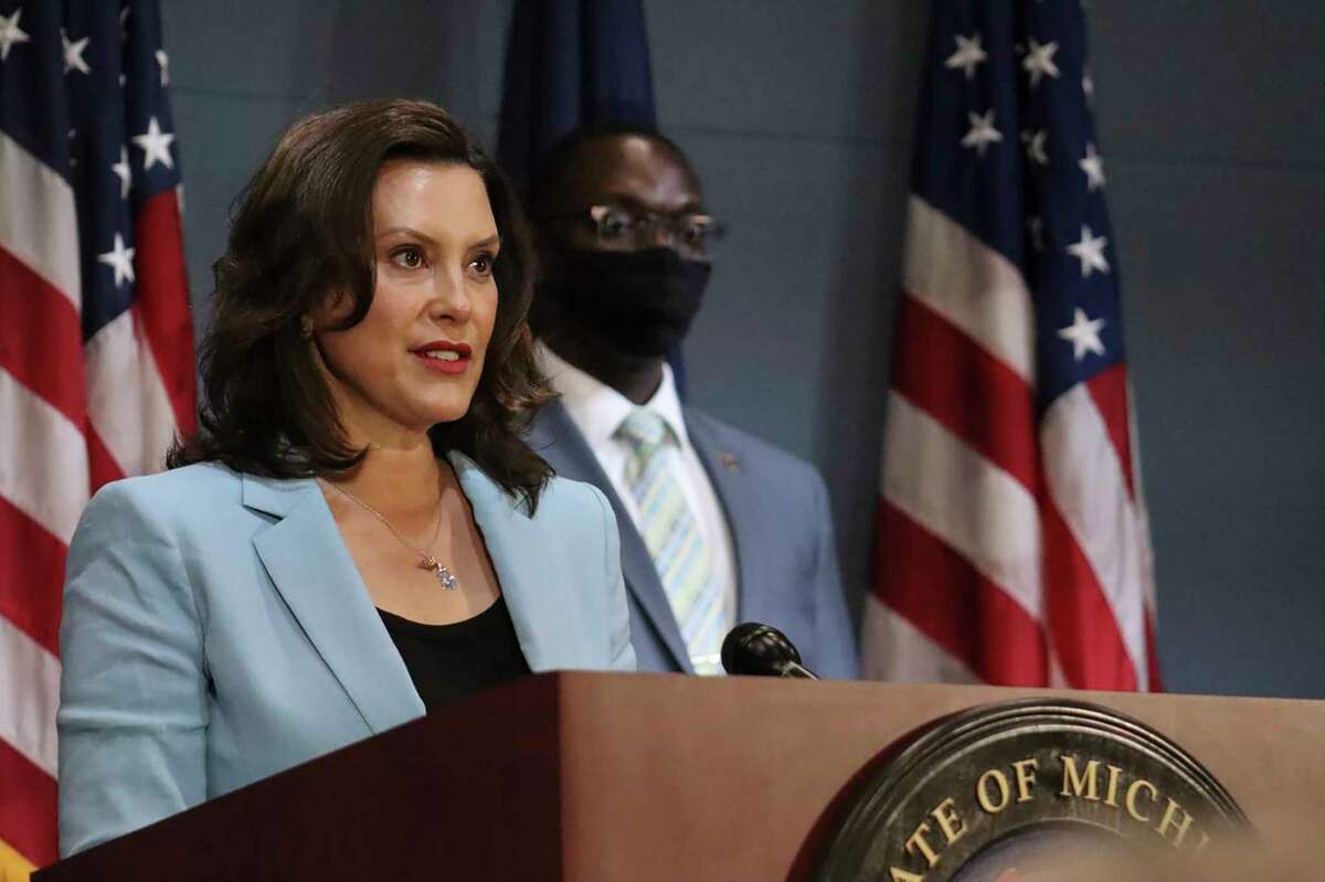 This July 9, 2020 file photo provided by the Michigan Office of the Governor shows Michigan Gov. Gretchen Whitmer as she addresses the state during a speech in Lansing, Mich. Gov. Whitmer on Friday, July 10, 2020, toughened a requirement to wear masks during the coronavirus pandemic, mandating that businesses open to the public deny service or entry to customers who refuse to wear one. (Michigan Office of the Governor via AP, Pool)