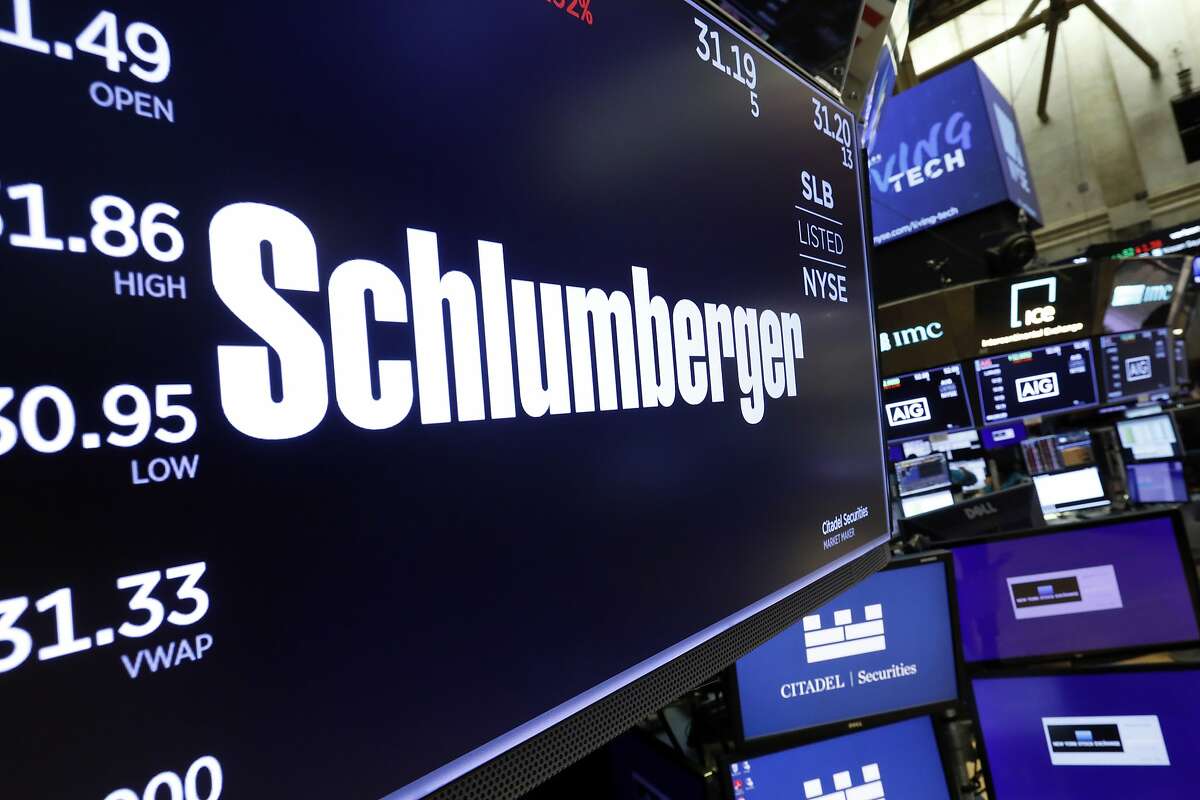 FILE - In this Oct. 8, 2019 file photo, the logo for Schlumberger appears above a trading post on the floor of the New York Stock Exchange.